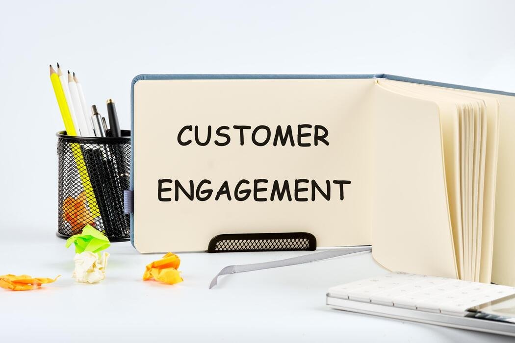 crm data management customer loyalty concept the concept of the info business the text of the customer engagement is written in a notebook on a blank sheet photo